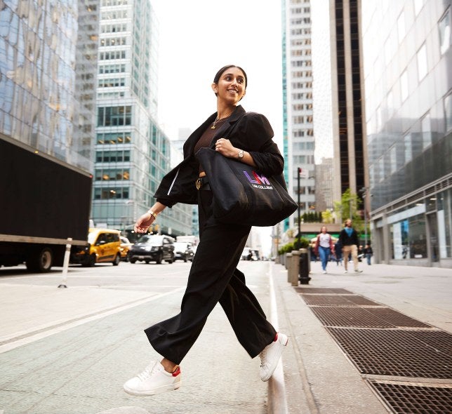 woman with LIM tote bag crossing street