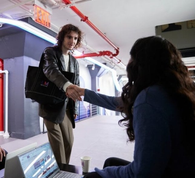 students shaking hands on Maxwell mezzanine 