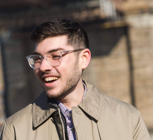 LIM alum Thomas J. Giangrande smiles as he speaks with someone while standing near the Brooklyn Bridge
