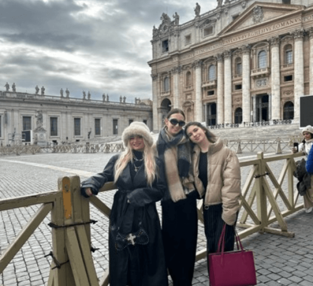 3 girls posing in front of a building