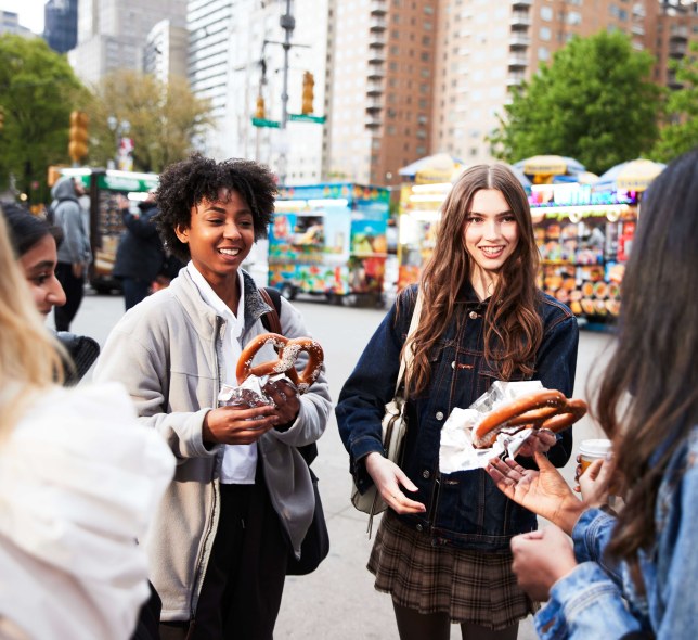 girls in a group eating pretzels