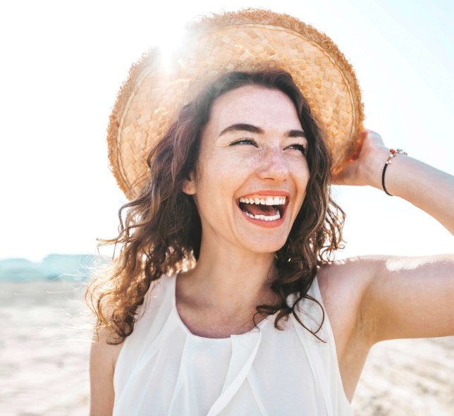 young woman in hat laughing