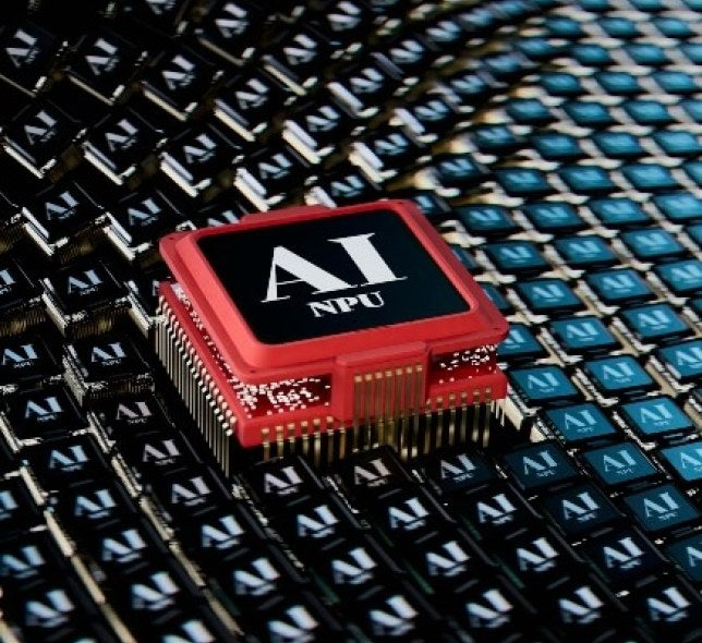 A red AI NPU chip sitting on a patterned surface of smaller black chips.
