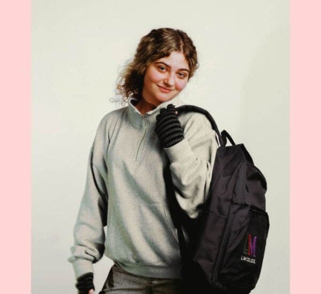 young woman, blond hair, LIM backpack, solid background