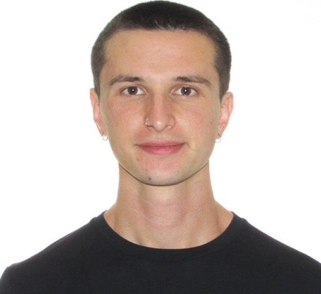 young man, dark-hair buzzcut, black shirt, medium close-up