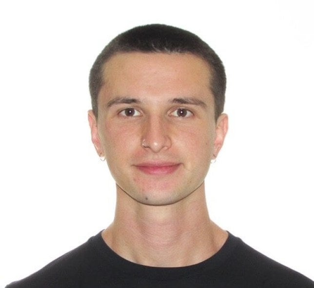 young man, dark-hair buzzcut, black shirt, medium close-up