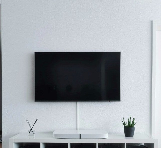 flatscreen tv against a white wall in a home