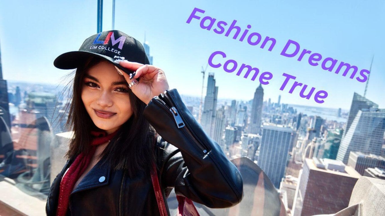 young woman, long dark hair, LIM baseball hat, leather jacket, top of Rockefeller Center sky deck.