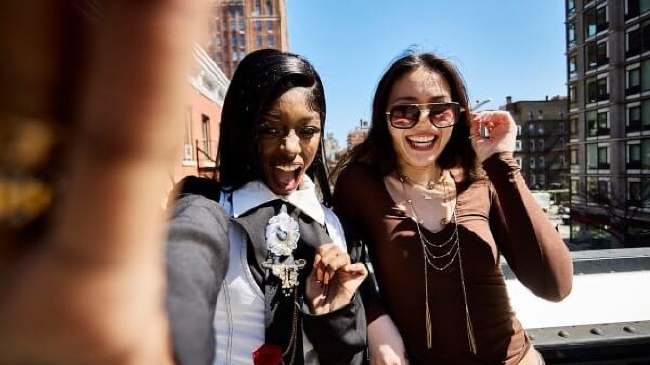 two students on The High Line in NYC, smiling, Chelsea//west side in background