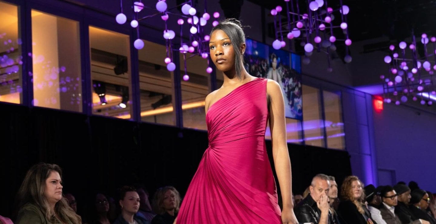 model in long pink gown walks to runway at 2026 Fashion Show