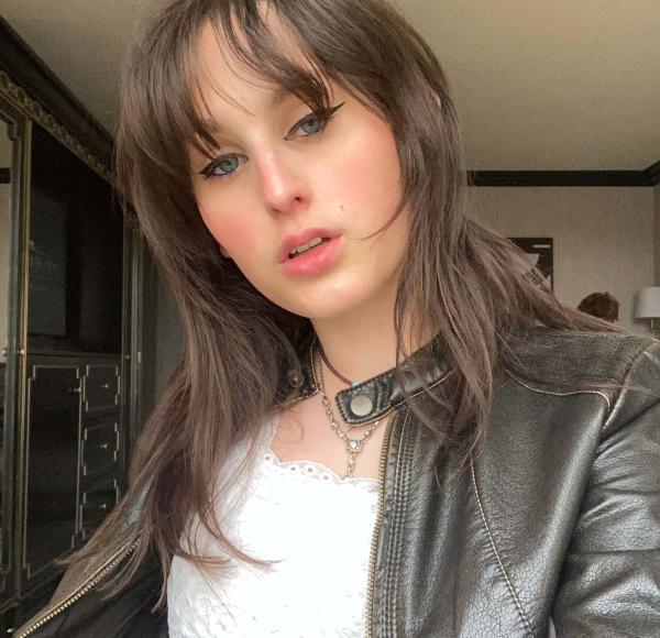 woman with brown hair in leather jacket, medium closeup