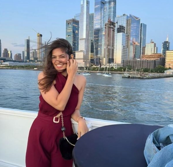 Aishwarya with water and city skyline in background