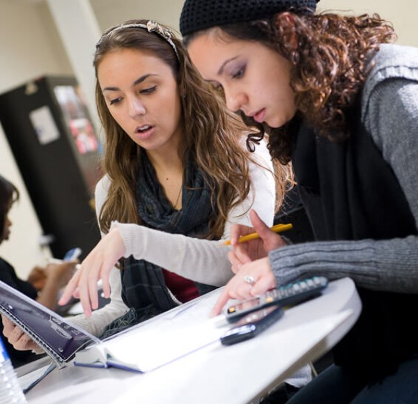 Two LIM College students working on an assignment