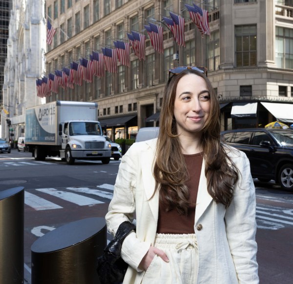 Woman on Fifth Avenue wearing light-colored suit.