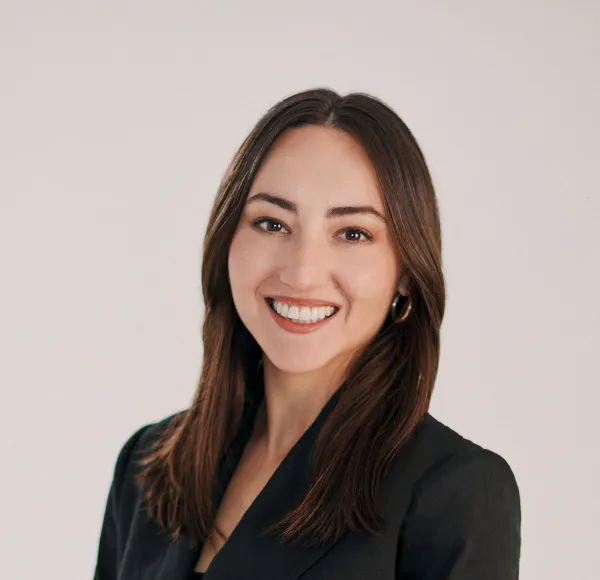 headshot of a woman wearing glasses in front of white background