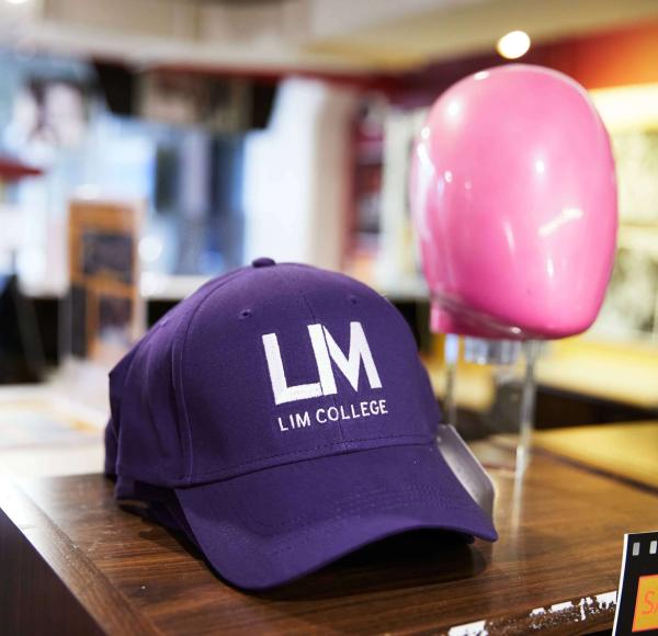 A purple LIM baseball cap sits on a display at the LIM Concept Shop