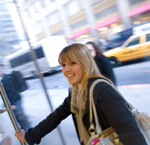 woman opening a door and walking through in New York