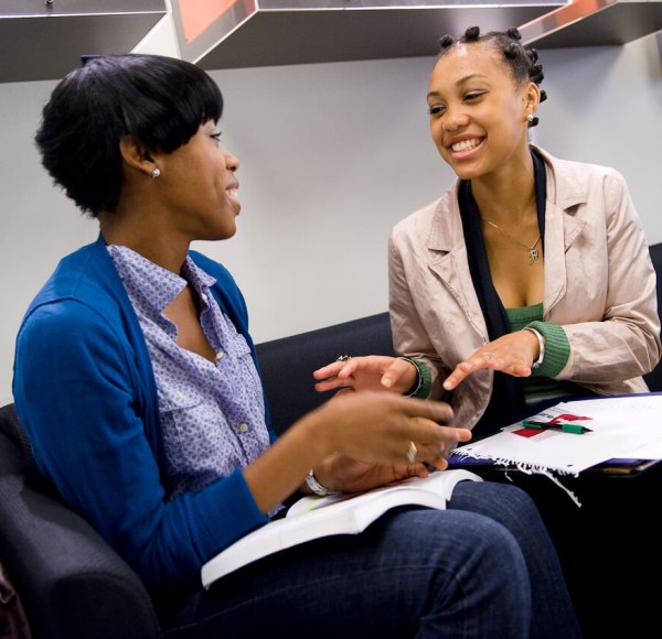 two stdents talking in an office