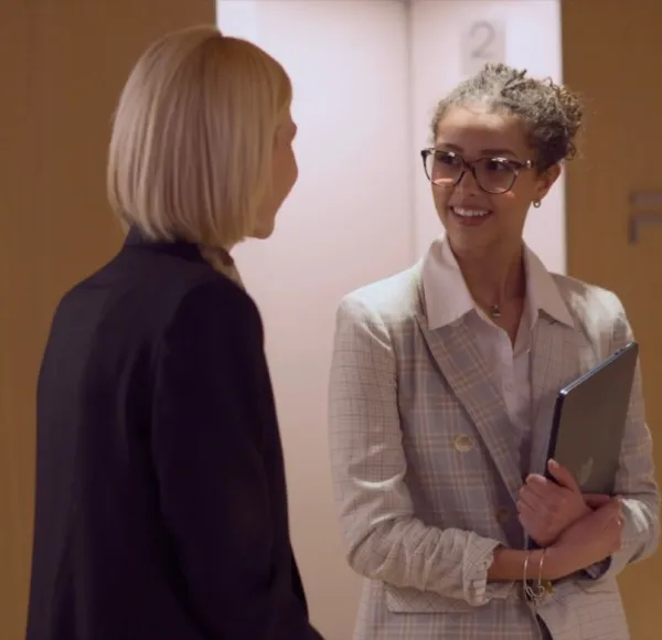 two women, professionally dressed, Fairchild Media Group office elevators