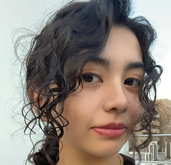 young woman, close-up shot, curly dark hair