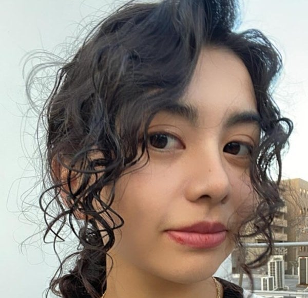 young woman, close-up shot, curly dark hair