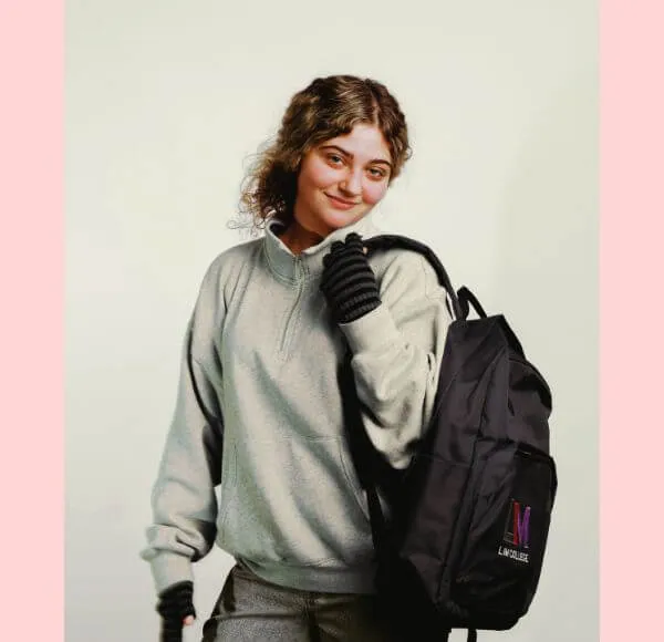 young woman, blond hair, LIM backpack, solid background