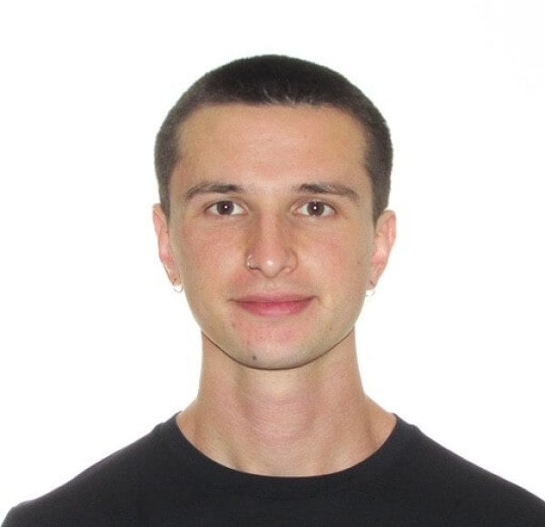 young man, dark-hair buzzcut, black shirt, medium close-up