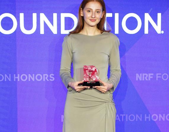 Megan Marr holding NRF Grand Prize award