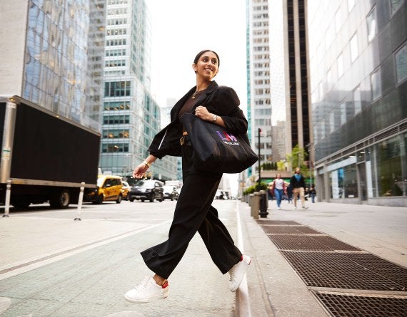 woman with LIM tote bag crossing street