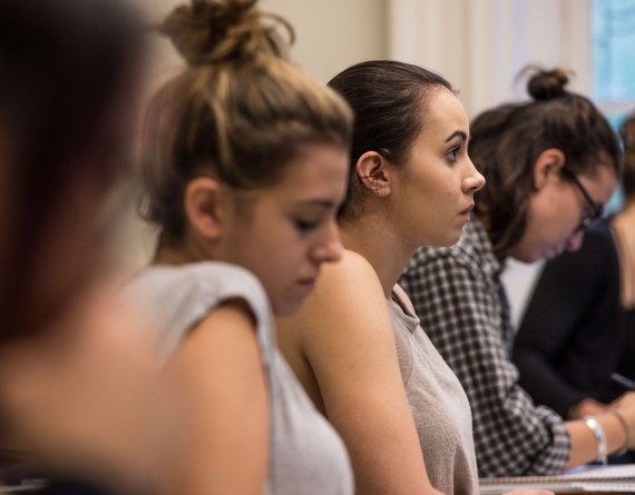 row of students in classroom, side angle