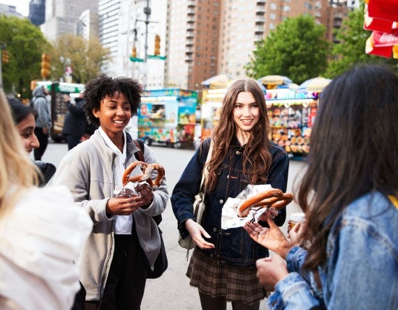 girls in a group eating pretzels