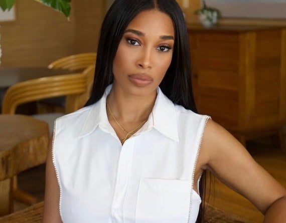 woman in jeans and a white collared shirt