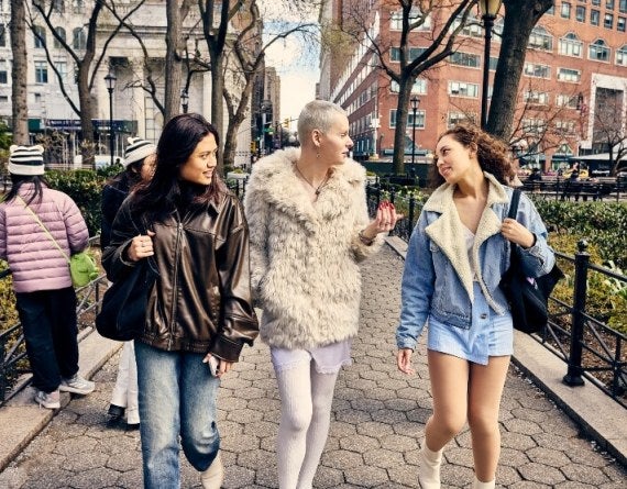 three students walk on hexagon pavers in New York City's Union Square.