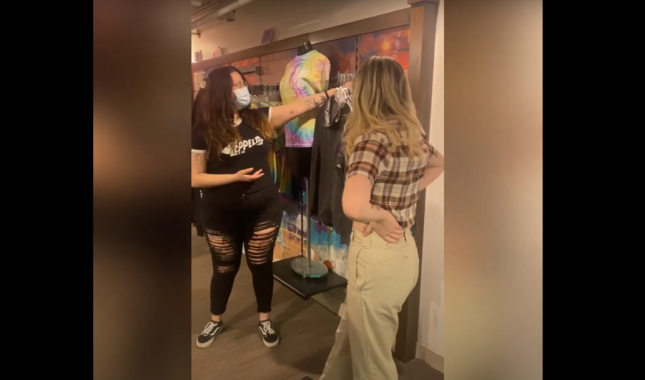 two students standing in concept shop, showing visual plan