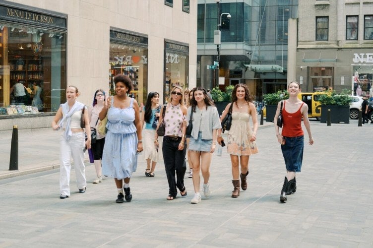 group of fashion students walk in Rockefeller Plaza