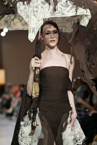 Fashion model with stylized umbrella on the runway at LIM College's 2026 Fashion Show