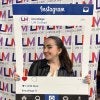 woman holding Instagram frame - LIM logo in background