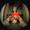 young woman, earrings, orange upper-bodywear, sneakers, fishbowl-lens shot