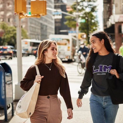 Two LIM College students walking down the sidewalk in the city