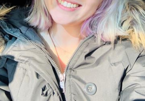 Image of girl with rainbow hair smiling