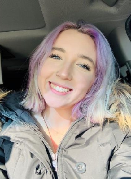 Image of girl with rainbow hair smiling