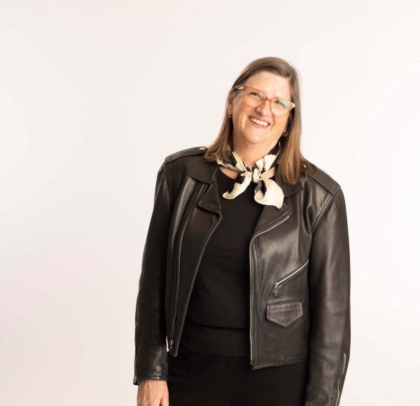 Professor Mitropoulos in leather jacket, white backdrop