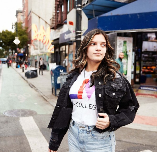 A female LIM student wears a LIM College shirt in the East Village