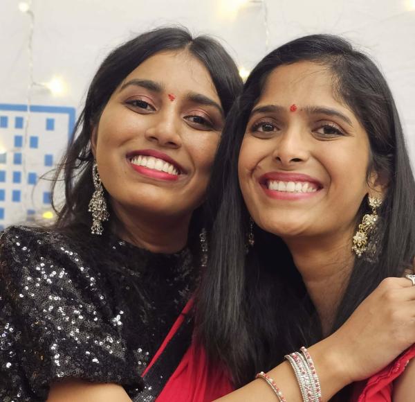 Two LIM students wear traditional Indian clothing and accessories to celebrate Diwali