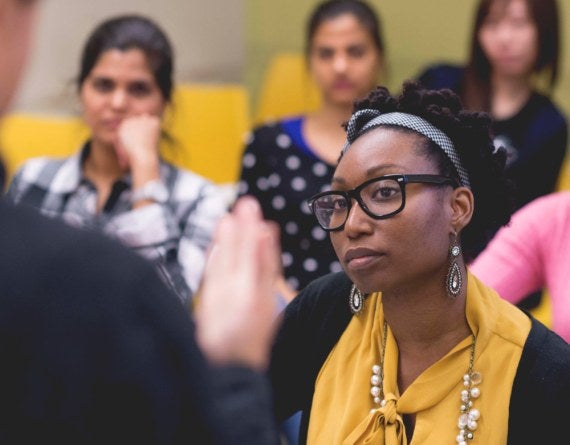 students in a classroom looking at a teacher