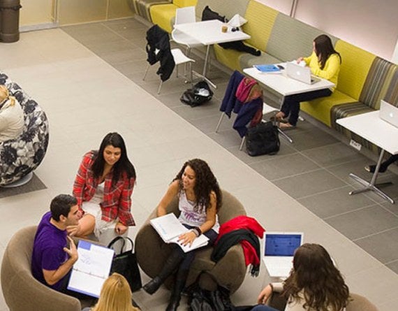 students sitting in a circle with opened books