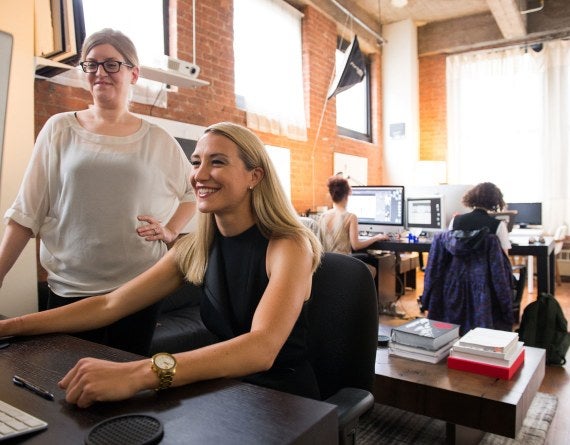 two women looking at a computer monitor in an office